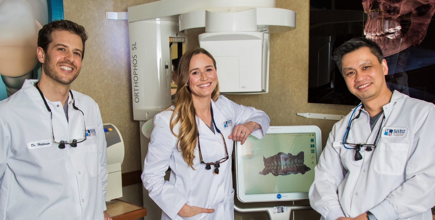 Three smiling dentists at Blue Back Dental