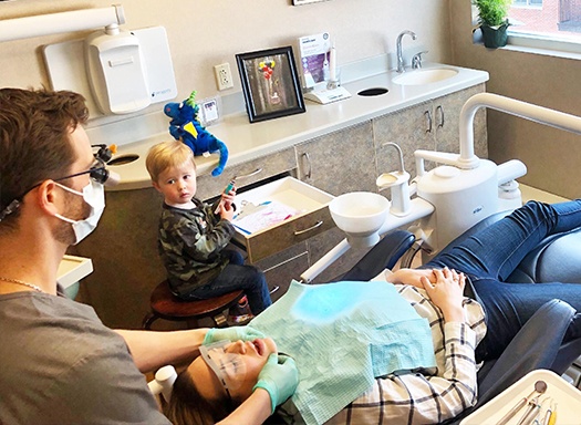 Dentist examining jaw joints of a patient