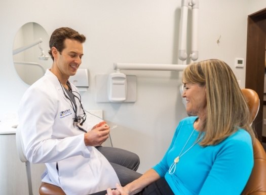 Dentist showing model of smile to a patient