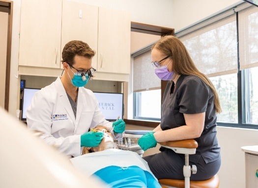 Doctor Tim and dental assistant treating a patient