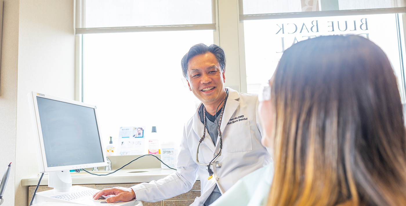 West Hartford and Avon cosmetic dentist Doctor Theodore K Wu smiling with a patient