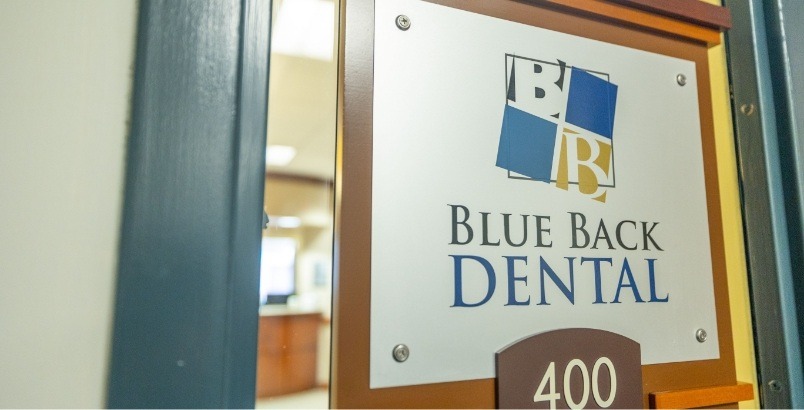 Blue Back Dental sign on outside of door of dental office in West Hartford or Avon