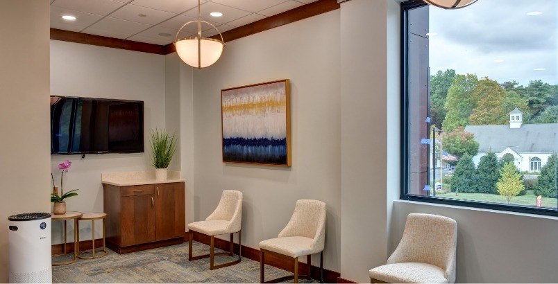 Reception area with forest visible through window