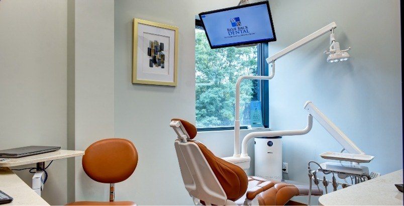 Dental treatment room with Blue Back Dental logo on computer monitor