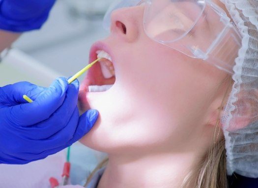 Dental patient having fluoride applied to their teeth